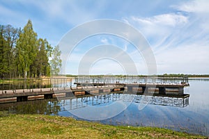 Metal pontoon bridge on the lake .