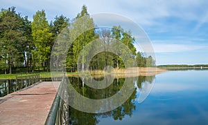 Metal pontoon bridge on the lake .