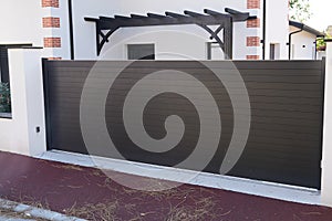 Metal portal sliding dark driveway entrance gates slide house access garage in suburb