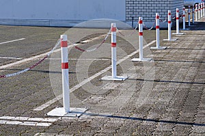 Metal posts with chains as boundary on a parking lot