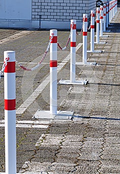 Metal posts in row linked with chain