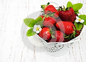 Metal pot with strawberries