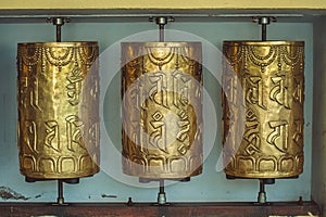 Metal prayer wheels with mantras in Dharamsala