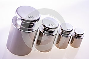 Metallic precision weights of different denominations. Sharpness at the largests