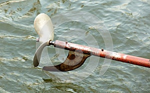 Metal propeller from a boat against the background of water