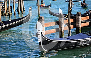 metal prows of traditional Venetian boats called GONDOLAS to transport of tourists photo