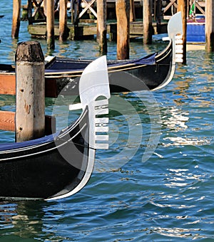 metal prows of traditional Venetian boats called GONDOLAS for the transport of tourists photo