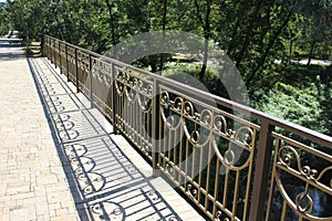 Metal railing of bridge and its shadow