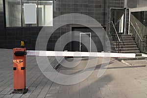 Metal railing on the sidewalk near the roadway. Close-up of the building.