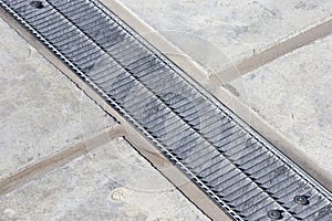 Metal rainwater collection grid in a car parking areas with concrete flooring