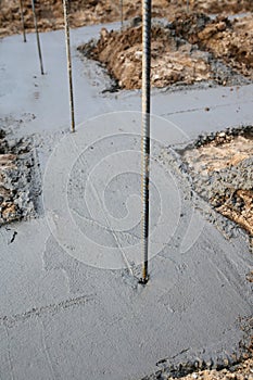 Metal Rebar sticking out of Concrete Poured Footing Foundation