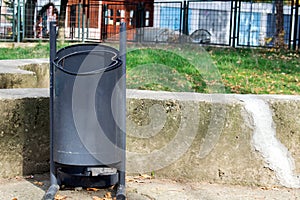 Metal recycle trash bin outside the park.