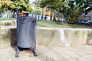 Metal recycle trash bin outside the park.