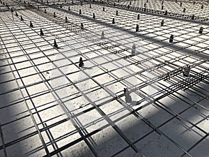 Metal reinforcement grid with plastic holders. Reinforced concrete preparation. Concrete basement construction