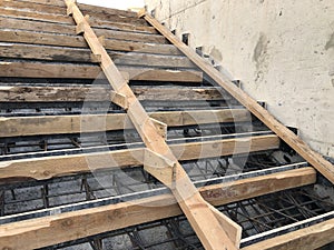 Metal reinforcement and wooden formworks of concrete stairway under construction