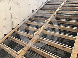 Metal reinforcement and wooden formworks of concrete stairway under construction