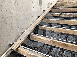 Metal reinforcement and wooden formworks of concrete stairway under construction