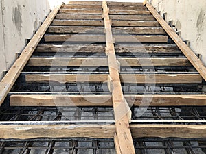 Metal reinforcement and wooden formworks of concrete stairway under construction