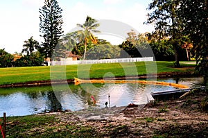 Metal retaining wall & yellow boom in water