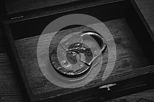 Metal retro padlock on wooden background