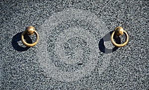 Metal ring on grave of cemetery. Rusty iron handle on granite tomb cover. An 19th century antique cemetery in Lvi