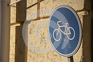 Metal road sign bicycle lane and wall