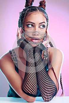 Metal, rock and beauty of a woman with makeup, bondage and bdsm style in a studio. Isolated, pink background and punk