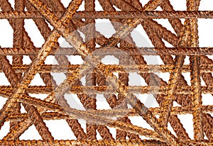 Metal rods in a chaotic manner with traces of rust on a white background