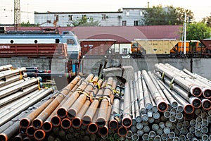 Metal rolling. Pipes folded in a railway warehouse are being prepared for shipment. The concept of metalworking and heavy industry