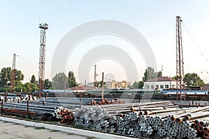 Metal rolling. Pipes folded in a railway warehouse are being prepared for shipment. The concept of metalworking and heavy industry