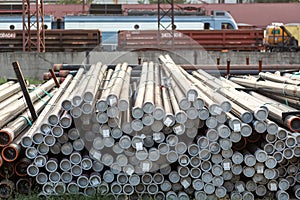Metal rolling. Pipes folded in a railway warehouse are being prepared for shipment. The concept of metalworking and heavy industry