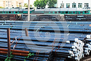 Metal rolling. Pipes folded in a railway warehouse are being prepared for shipment. The concept of metalworking and heavy industry