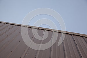 A metal roof against a blue sky