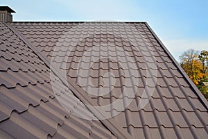 Metal Roof Construction Against Blue Sky. Roofing materials. Metal House roof. Closeup House Construction Building Materials.