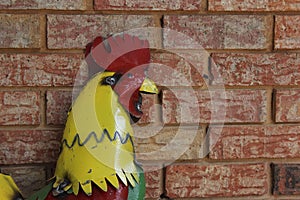 Metal Rooster on Brick Wall. Rural East Texas Scenery
