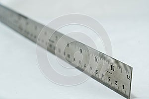 Metal ruler blurred on white background