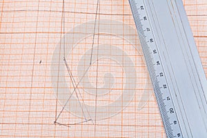 Metal ruler at graph paper