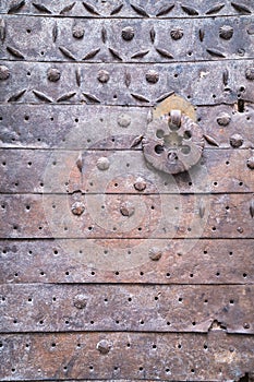Metal rust door with a forged pattern with rings for knocking