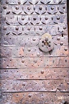 Metal rust door with a forged pattern with rings for knocking