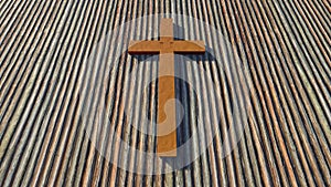 Metal rusted cross on a natural wood or wooden logg background. 3d illustration metaphor for God, Christ photo