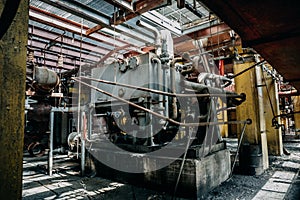 Metal rusty equipment and tools in abandoned factory inside