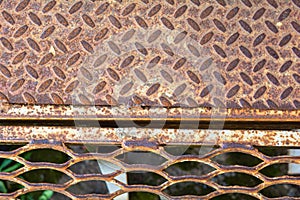 Metal rusty grill. Rustic lattice. Grate for cleaning shoes from metallic lines