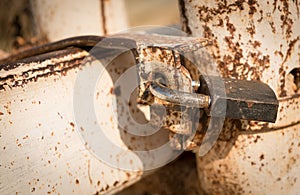 Metal rusty padlock on a closed gate