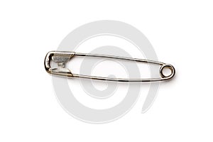 Metal safety pin on white background