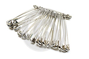 Metal safety pins isolated on white background