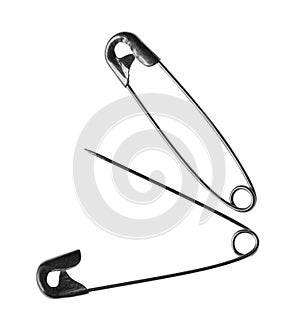 Metal safety pins on white background, top view