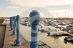 Metal safety posts and chain along the quayside at Pwllheli Marina in North Wales