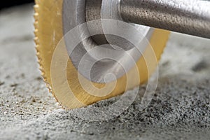 Metal saw, end mill or drill bit with diamond coating makes hole in concrete slab. Industry and construction