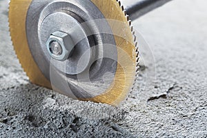 Metal saw, end mill or drill bit with diamond coating makes hole in concrete slab. Industry and construction