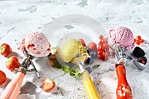 Metal scoops with berry and pistachio ice-cream